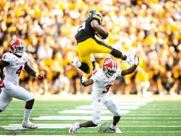 Iowa's Tyler Goodson hurdles an Indiana defender